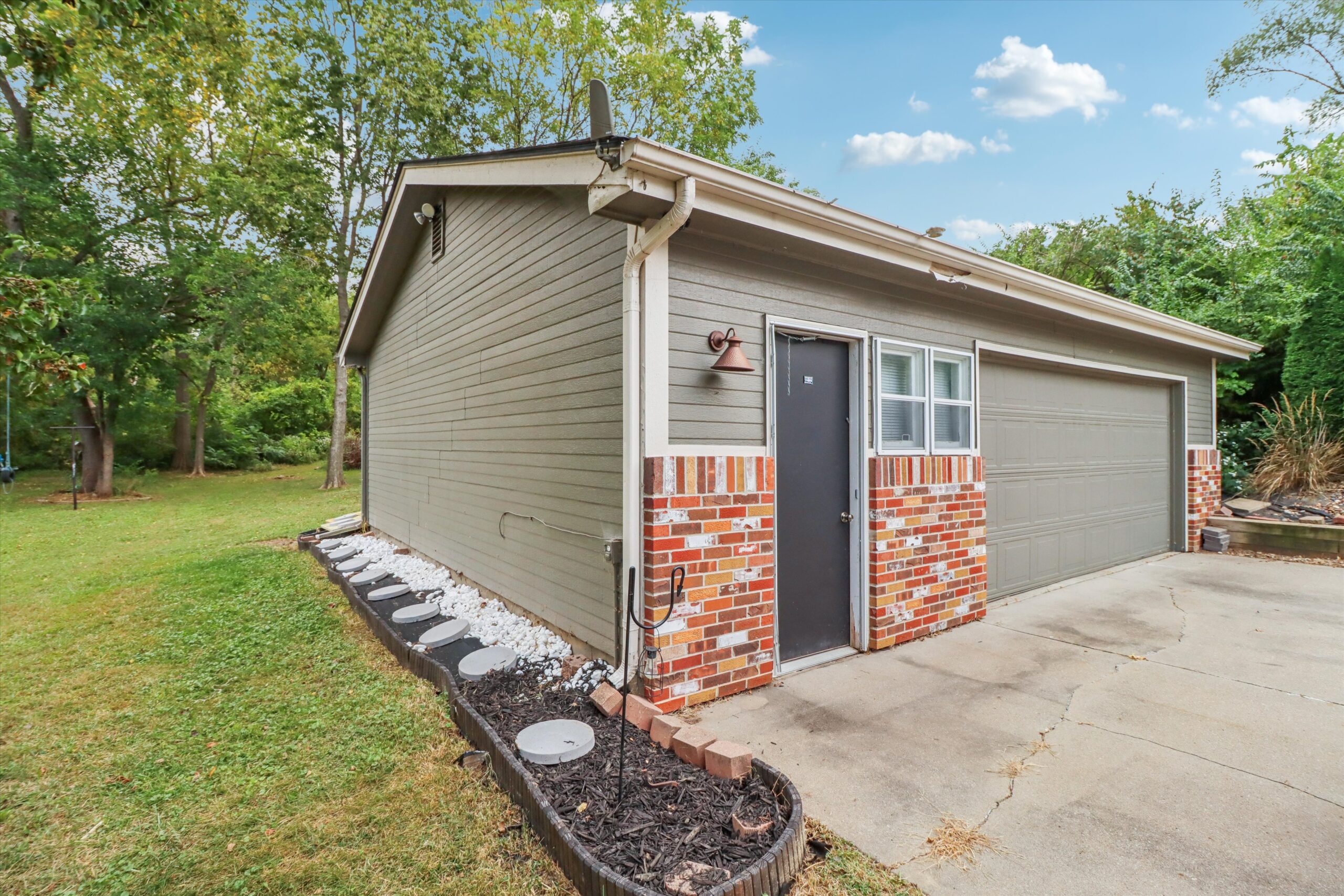 Screened-in porch at 545 Christie Lane Pleasant Hill Iowa overlooking backyard