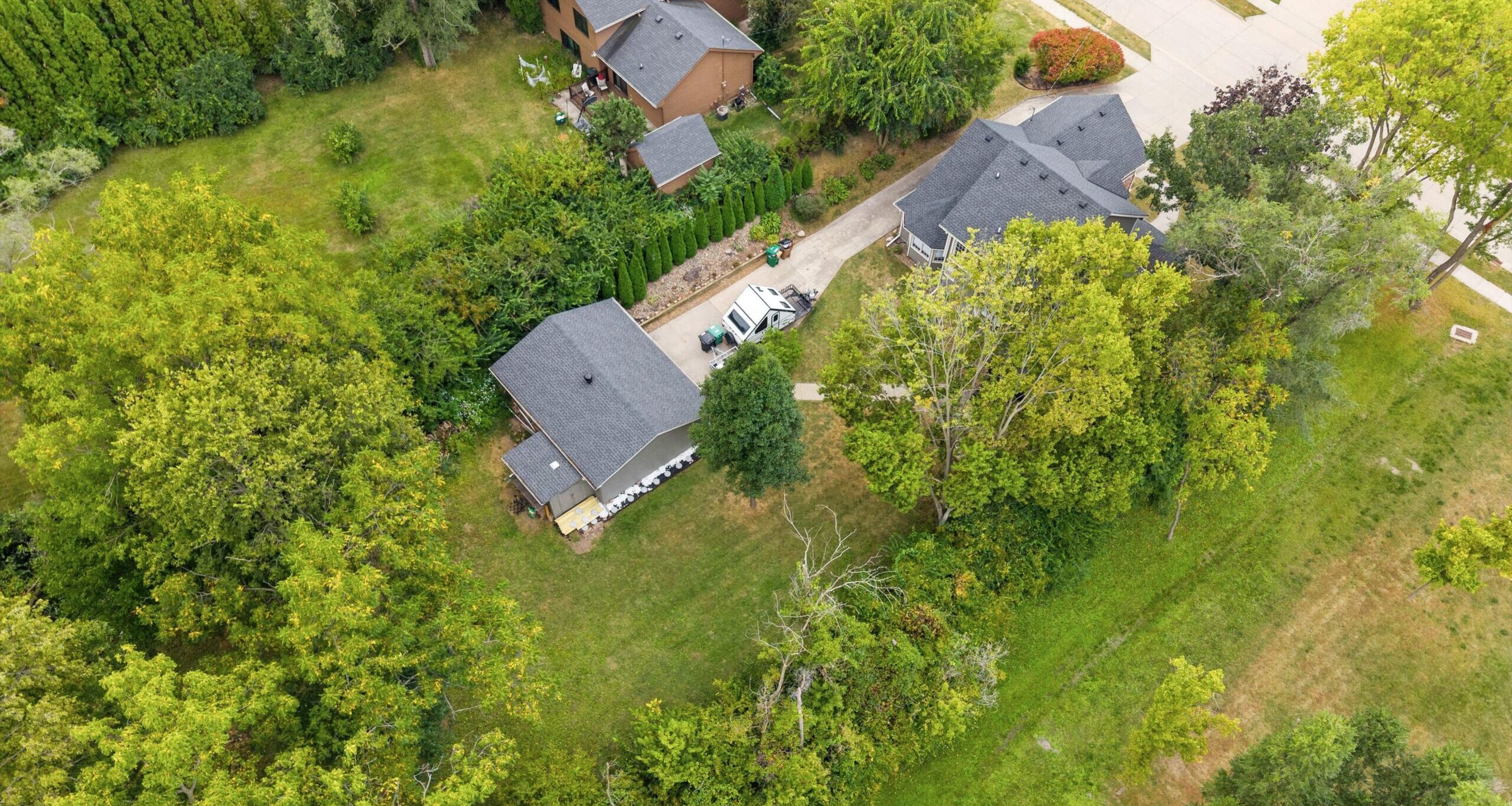 Backyard of 545 Christie Lane Pleasant Hill Iowa half-acre lot with mature trees